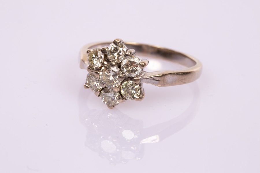 A diamond seven-stone cluster ring set in 18ct white gold, total diamond weight approximately 0.