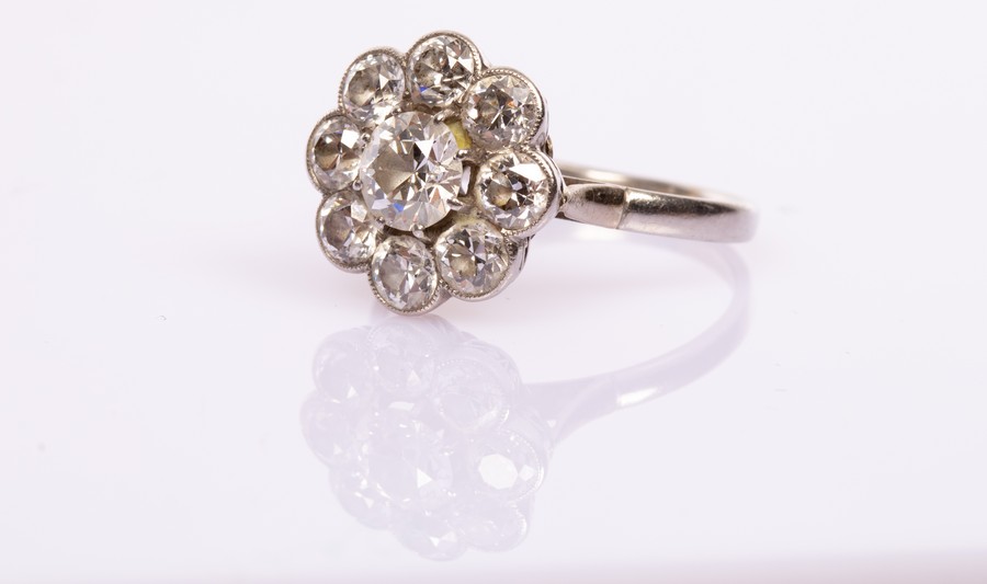 A diamond cluster ring, the nine old brilliant cut cluster with central stone of approximately 0.