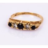 A sapphire and diamond five-stone ring, in an 18ct yellow gold scroll setting, size Q,