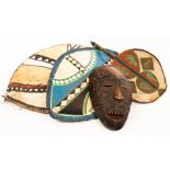 Two painted hide tribal shields, the larger 78cm high,