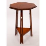 An Arts & Crafts style oak occasional table, the octagonal top on pierced tapering legs,