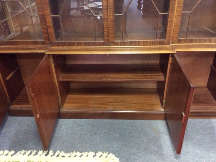 A mahogany breakfront bookcase, the glazed doors with panel doors beneath, - Image 2 of 4