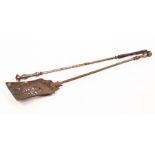 An early 19th Century coal shovel with a pierced fish tail shaped scoop and turned handle and a