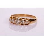 A Victorian five-stone diamond ring in an 18ct yellow gold scroll setting,