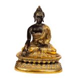 A 19th Century bronze and gilt bronze figure of Buddha Shakyamuni, Tibet, seated,