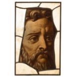 A fragment of 17th Century stained glass, head of a bearded figure, from Eton College Chapel,