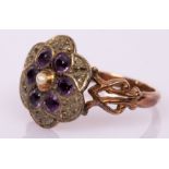 An Edwardian amethyst, diamond and pearl cluster ring,