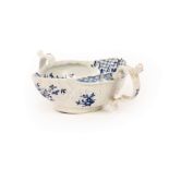 A Worcester blue and white double-lipped sauce boat, circa 1755-58, modelled with shell-shaped lips,