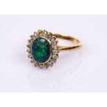 A black opal and diamond cluster ring, the oval opal to a surround of twenty diamonds,