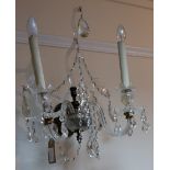 A pair of 19th Century cut glass and brass two-branch wall lights with serpentine arms,