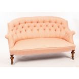 A late Victorian two-seater settee with button upholstered back on turned front legs with castors,