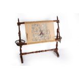 A stained beech tapestry loom with turned upright and spindle turned thread basket to each support,