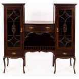 An Edwardian mahogany display cabinet with central bowfront section fitted a drawer above a recess,