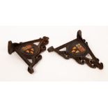A pair of cast iron wall brackets, each with double sided roundel of the Eton coat of arms,