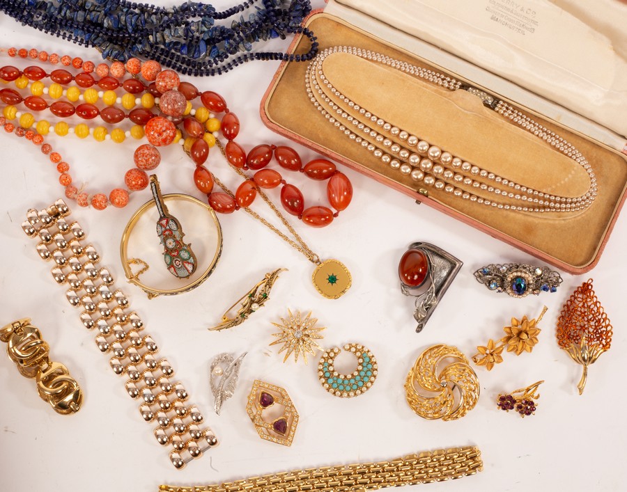 A large quantity of costume jewellery to include a lion brooch by Grosse,