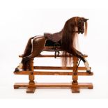 An early 20th Century rocking horse by G & J Lines Brothers with glass eyes,