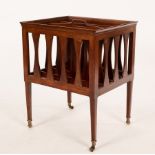 An Arts & Crafts period mahogany Canterbury with incorporated handle, on tapering feet and castors,