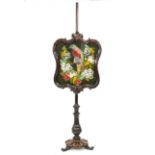 An early Victorian pole screen, the needlework and beadwork panel depicting a parrot,