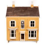 An early 20th Century large doll's house of eight rooms, to include a drawing room, dining room,