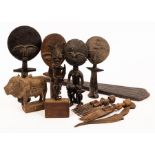 A quantity of tribal carvings to include a paddle,