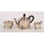 A silver three-piece tea service, WD, Birmingham 1903, with flanged borders raised on three feet,