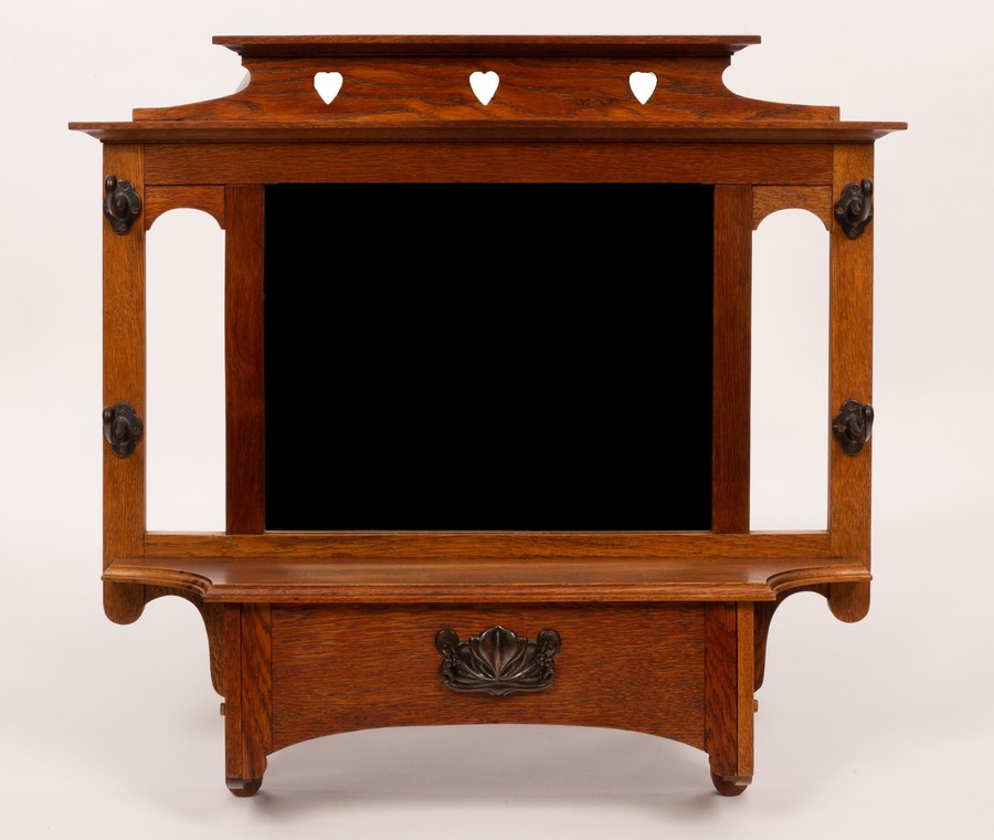 An Art Nouveau oak hall mirror, with coat hooks and glove box below, 81.