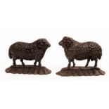 A near pair of cast iron doorstops modelled as sheep, 18.5cm and 17.