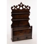 An 18th Century oak spoon rack with pierced surmount and two racks, each for six spoons,