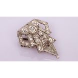 An Art Deco diamond clip of stylised triangular shape,