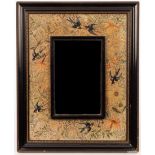 A needlework framed wall mirror, swallows amidst foliage,