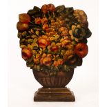 A floral decorated fireplace board in the shape of a large vase of flowers,