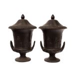 A pair of early 20th Century Wedgwood black basalt twin-handled campana urns and covers,