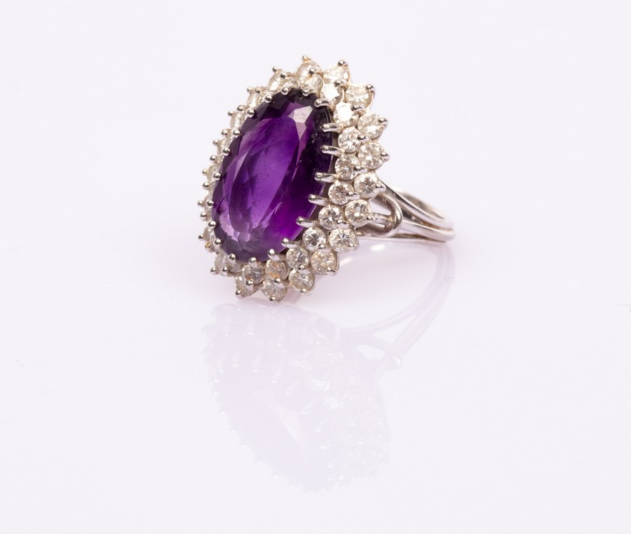 An amethyst and diamond oval cluster ring,