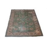 A rug of Persian design, the lime green ground decorated stylised floral designs,