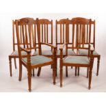 A set of six Arts & Crafts walnut dining chairs, each carved a roundel to the crest,