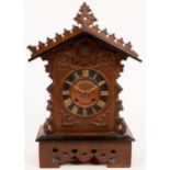 A Black Forest cuckoo clock, the case with Gothic style carving,