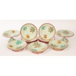 A Minton floral dessert service decorated foliage on an apple green ground,