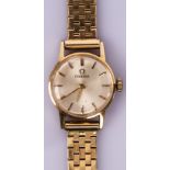 A lady's 14ct gold cased Omega wristwatch, the circular dial with gilt baton hour markers,