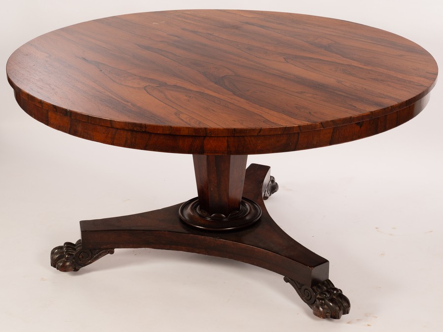 A William IV circular rosewood table on an inverted tapered octagonal support, with tripod base,