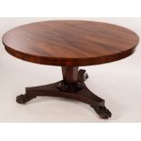 A William IV circular rosewood table on an inverted tapered octagonal support, with tripod base,