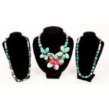 A faux turquoise and coral necklace of multi flowerhead design,