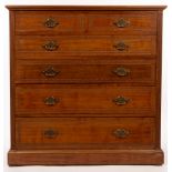 An Edwardian walnut chest of two short over four long drawers, stamped Jas Shoolbred & Co.