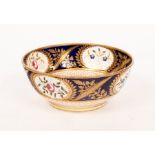 A Minton bowl, finely painted flowers on a powder blue ground within gilt borders,