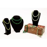 Various jadeite bead necklaces and bracelets in a wooden box with mosaic type cover