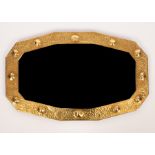 An Arts & Crafts style brass framed wall mirror, with hammered finish,