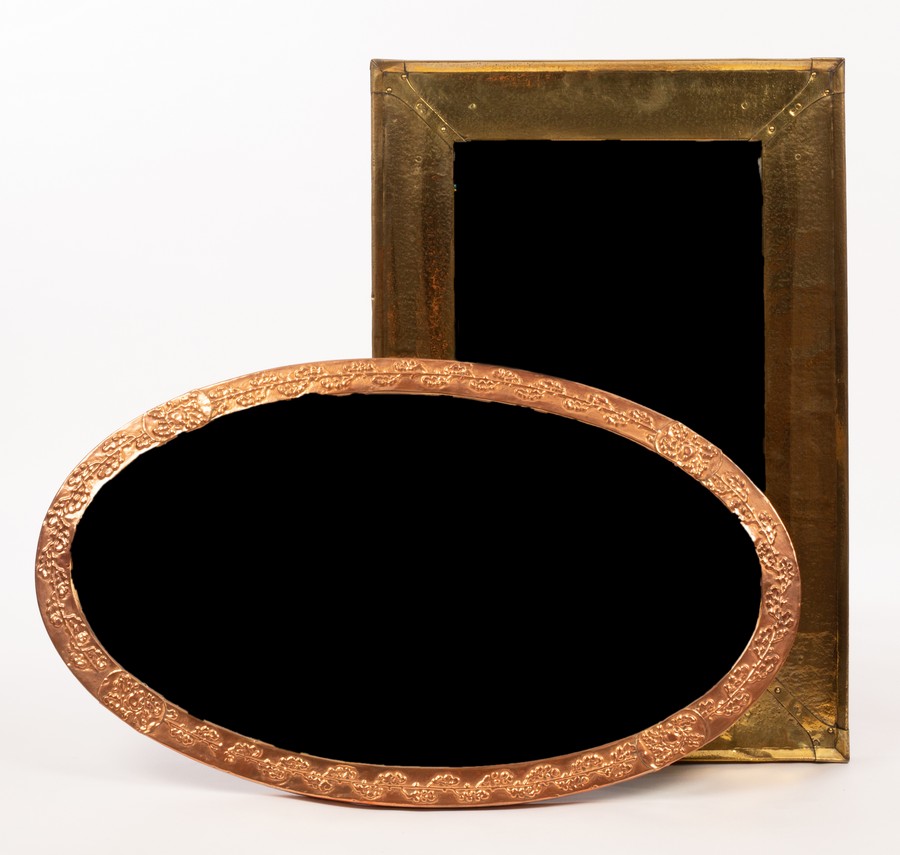 An oval copper framed mirror, 47cm x 80.5cm and a brass mirror of shaped oblong form, 38.