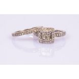 A diamond dress ring of square cluster shape with diamond set shoulders to a 18ct white gold shank,