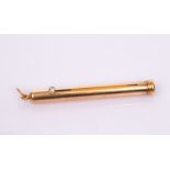 A gold propelling pencil by The Goldsmiths Company, with diamond set 'button',