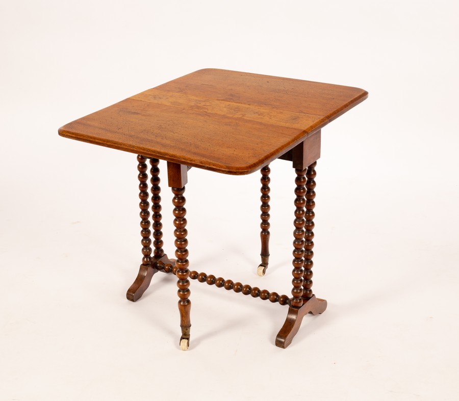 A walnut two-flap table on bobbin turned legs,