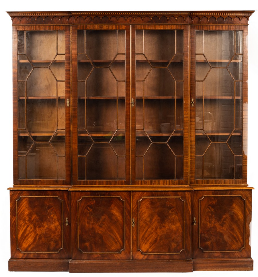 A mahogany breakfront bookcase, the glazed doors with panel doors beneath,
